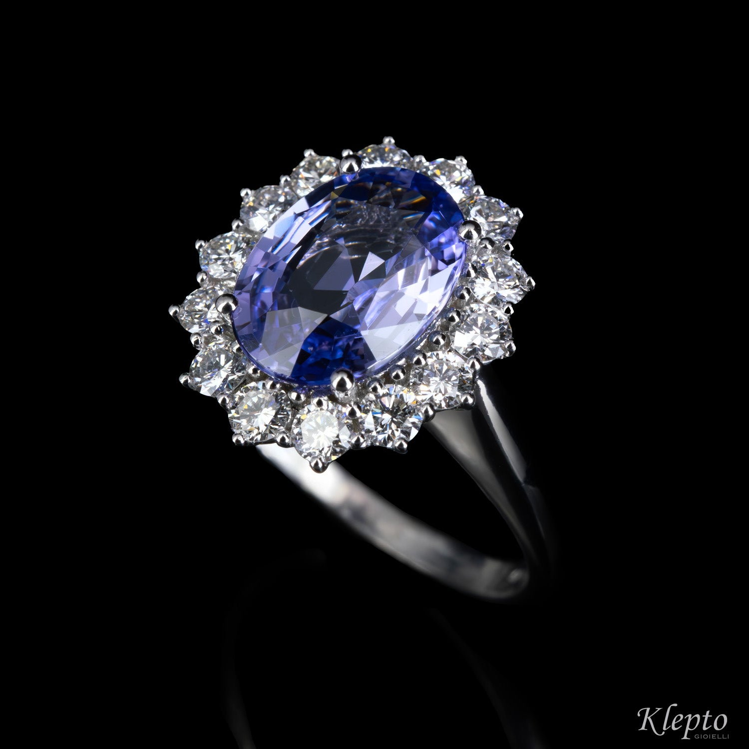 Classic white gold ring with blue sapphire and diamond surround