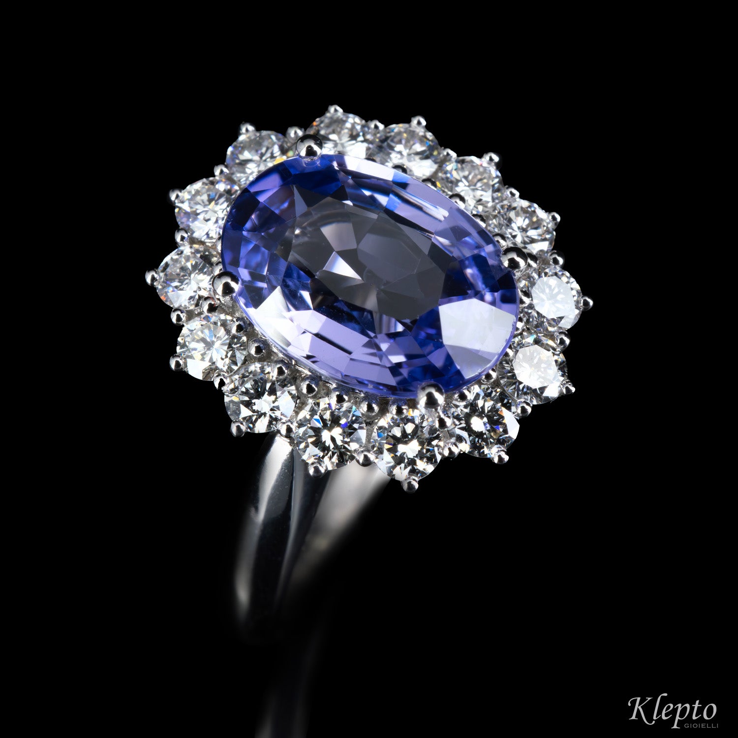 Classic white gold ring with blue sapphire and diamond surround