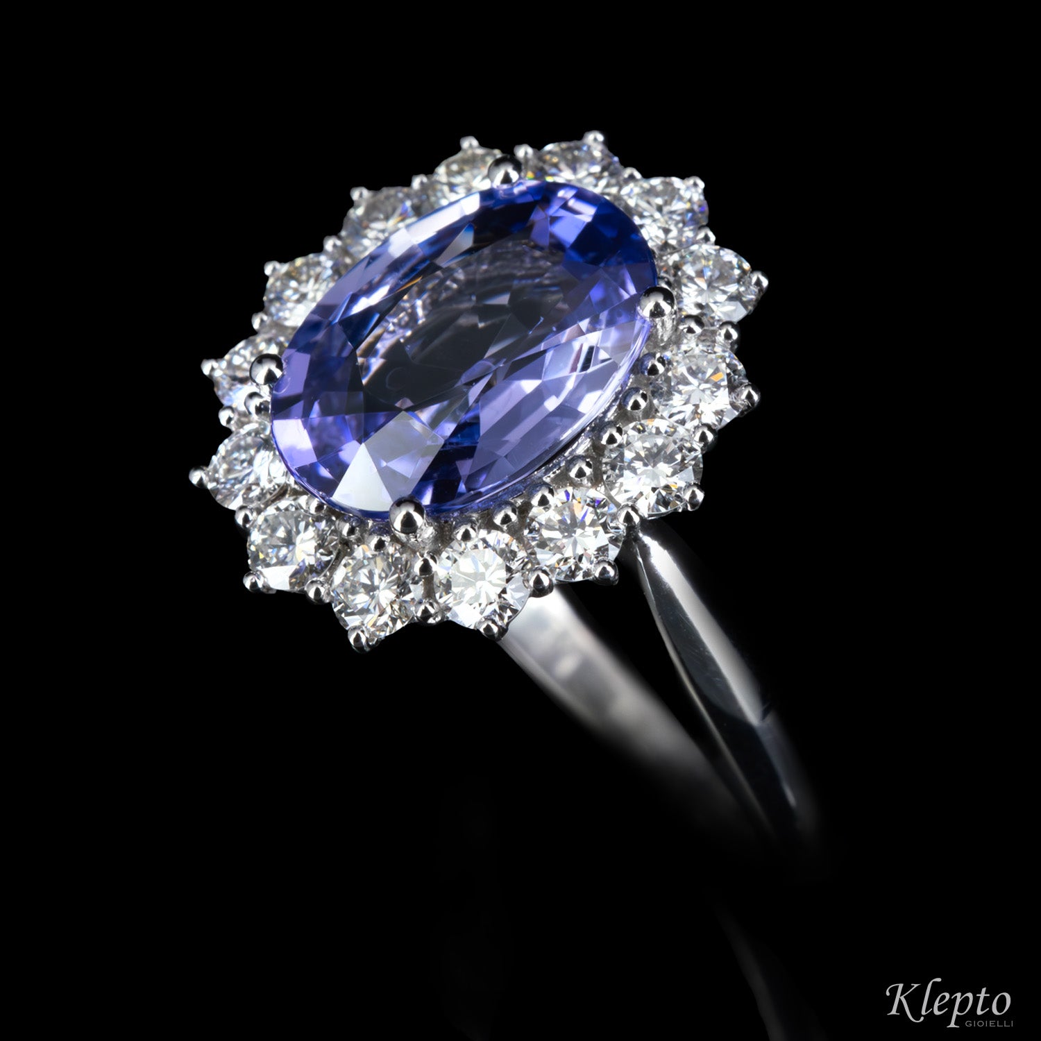 Classic white gold ring with blue sapphire and diamond surround