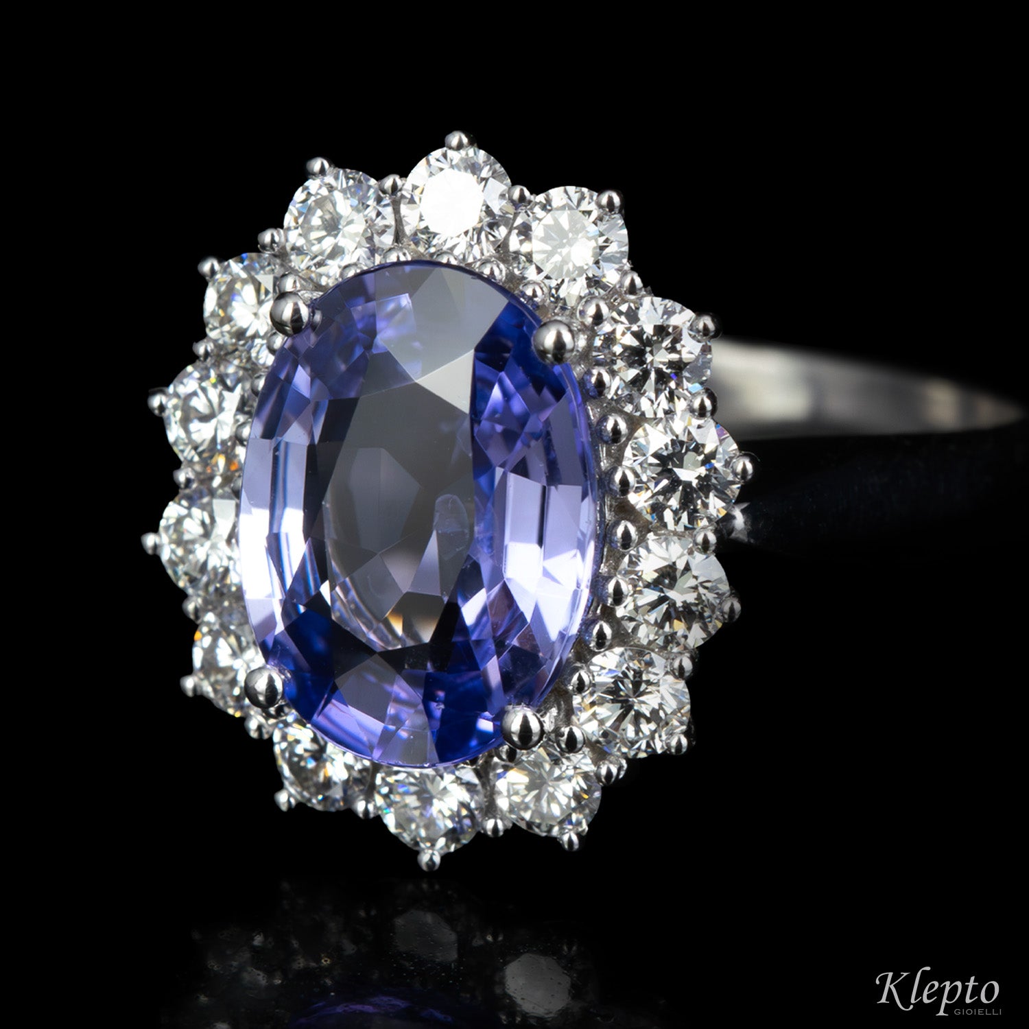 Classic white gold ring with blue sapphire and diamond surround