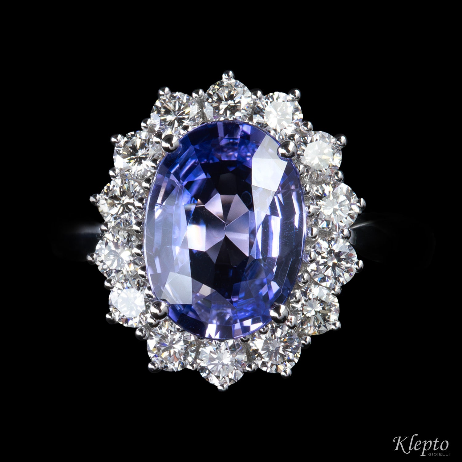 Classic white gold ring with blue sapphire and diamond surround