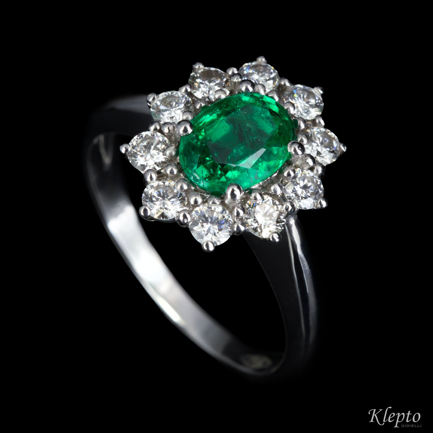 Classic ring in white gold with Emerald and diamond surround