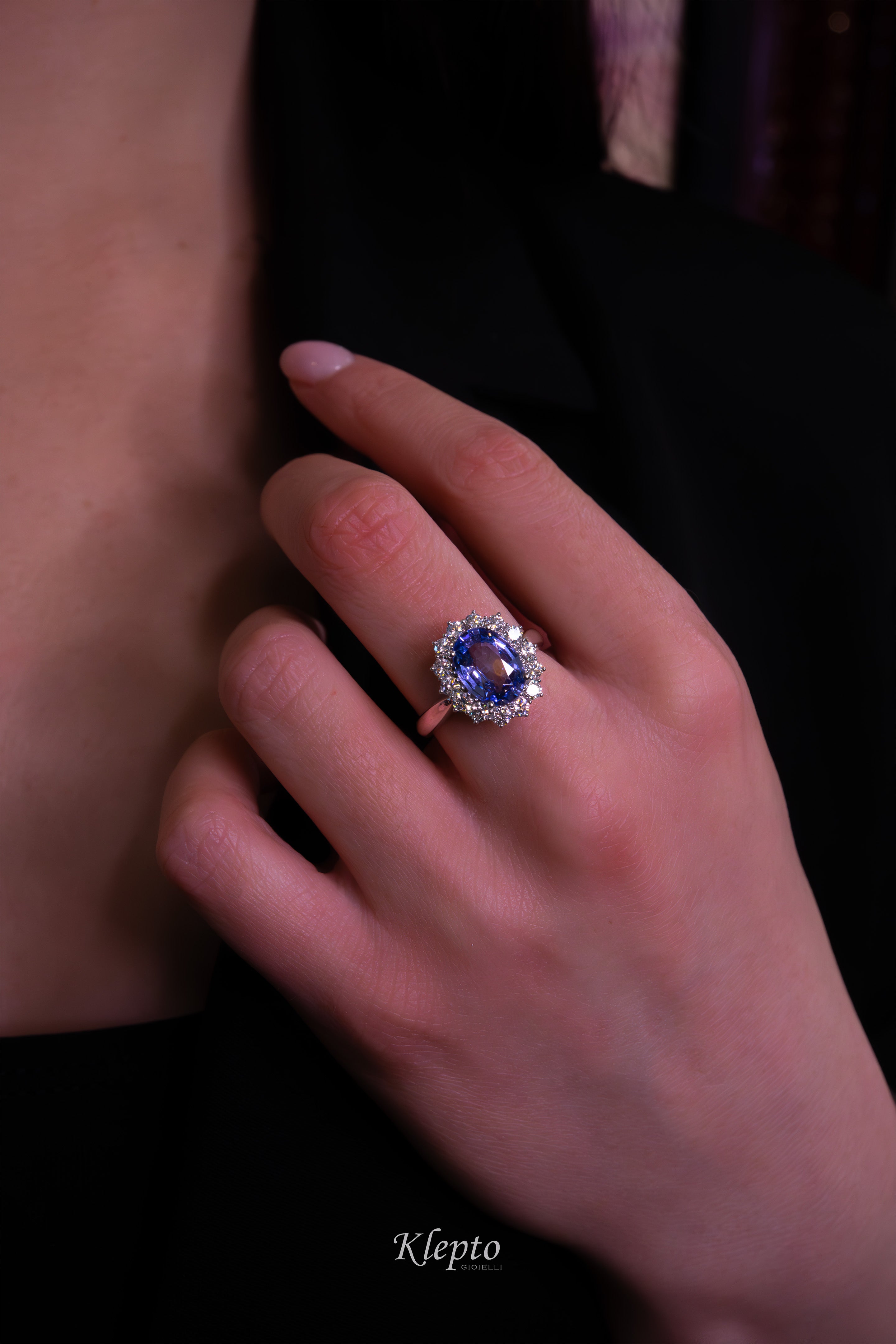 Classic white gold ring with blue sapphire and diamond surround