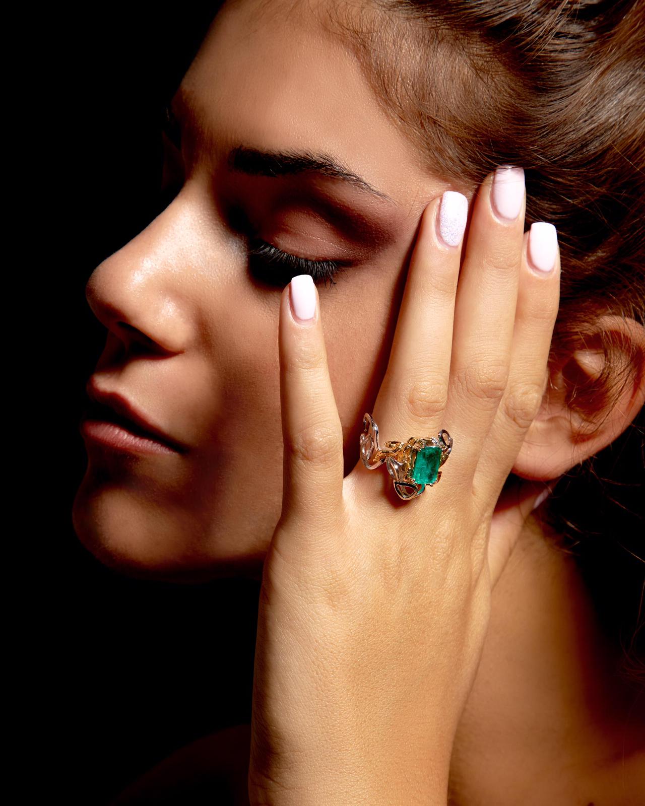 White gold ring with Emerald, Diamond, and yellow gold details