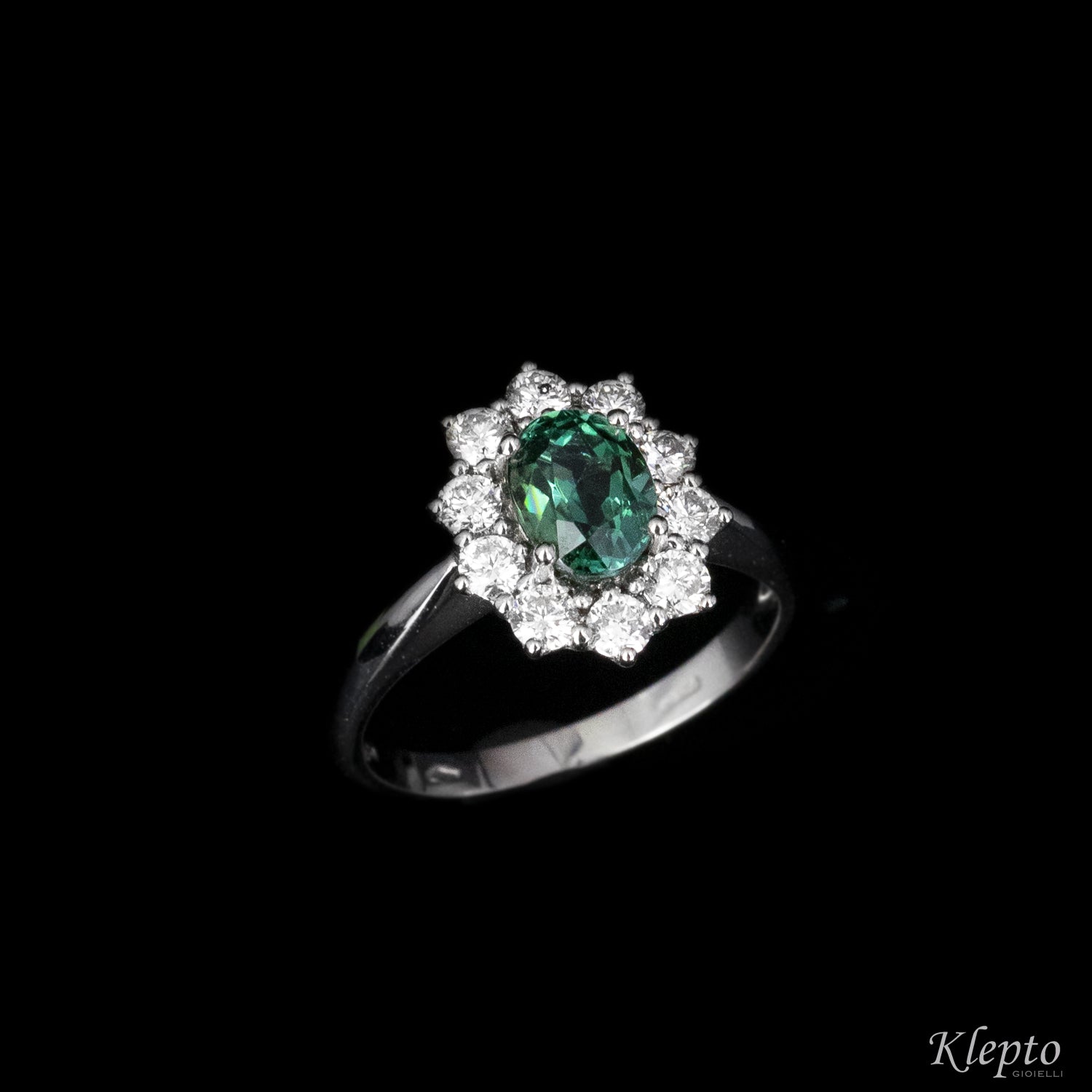 Classic white gold ring with green tourmaline and diamond surround