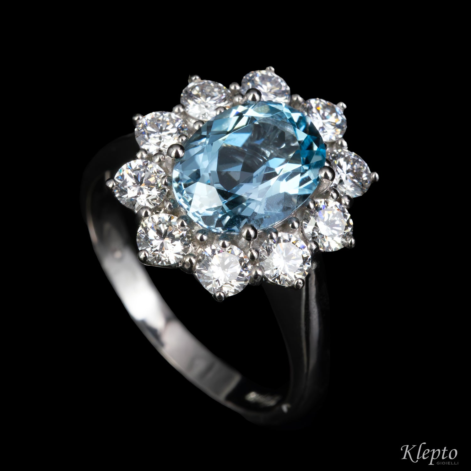 Classic white gold ring with Aquamarine and a diamond halo