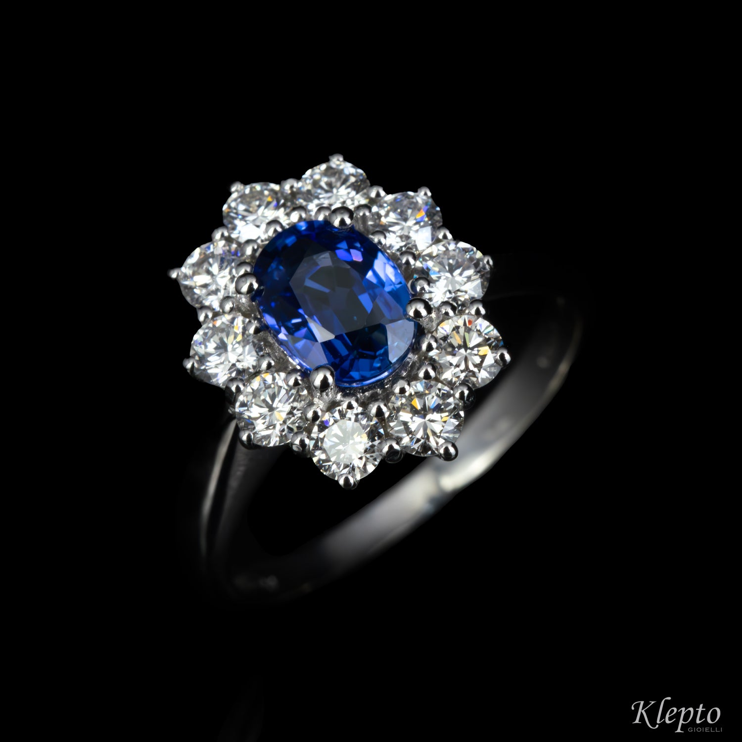 Classic white gold ring with blue sapphire and diamond surround