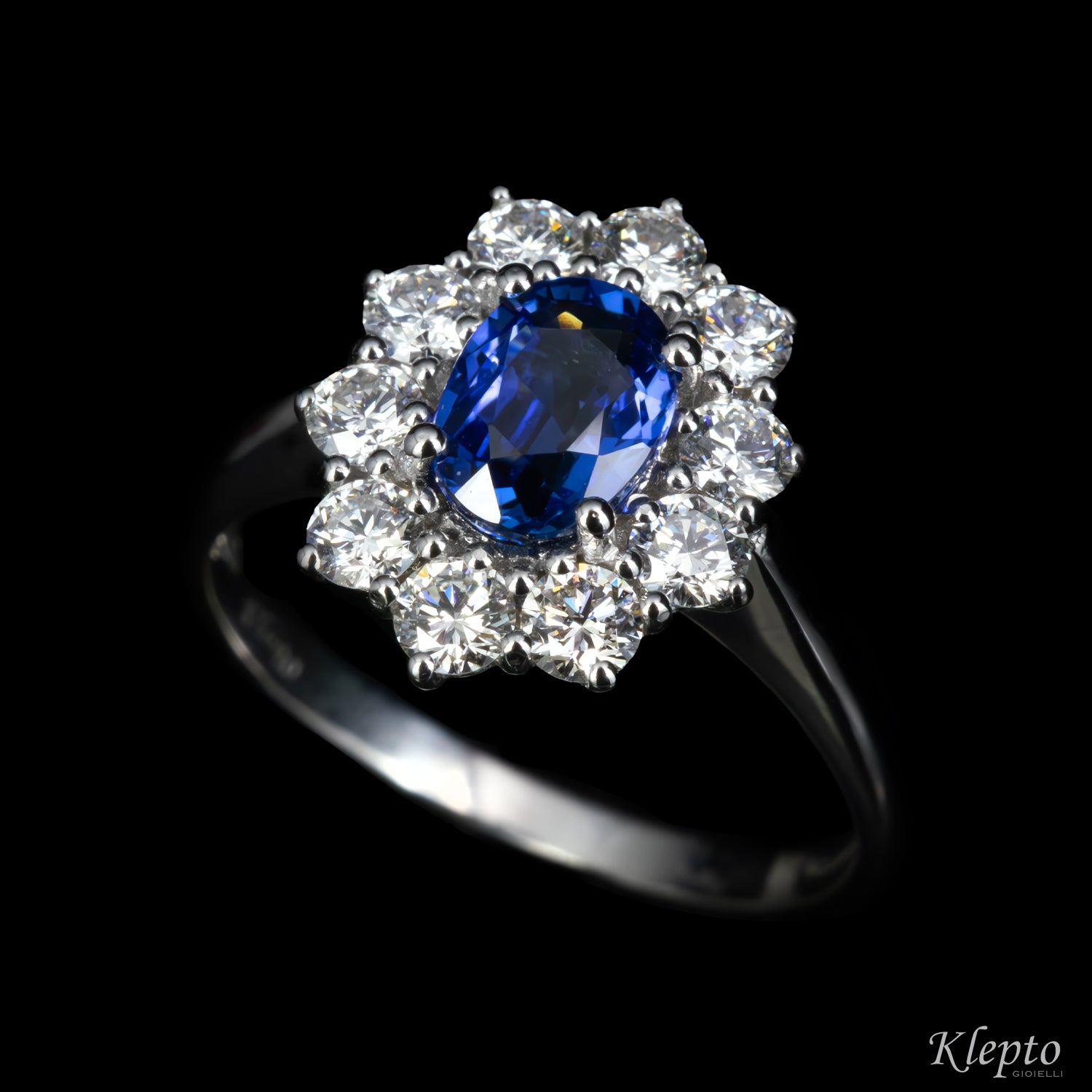 Classic white gold ring with blue sapphire and diamond surround