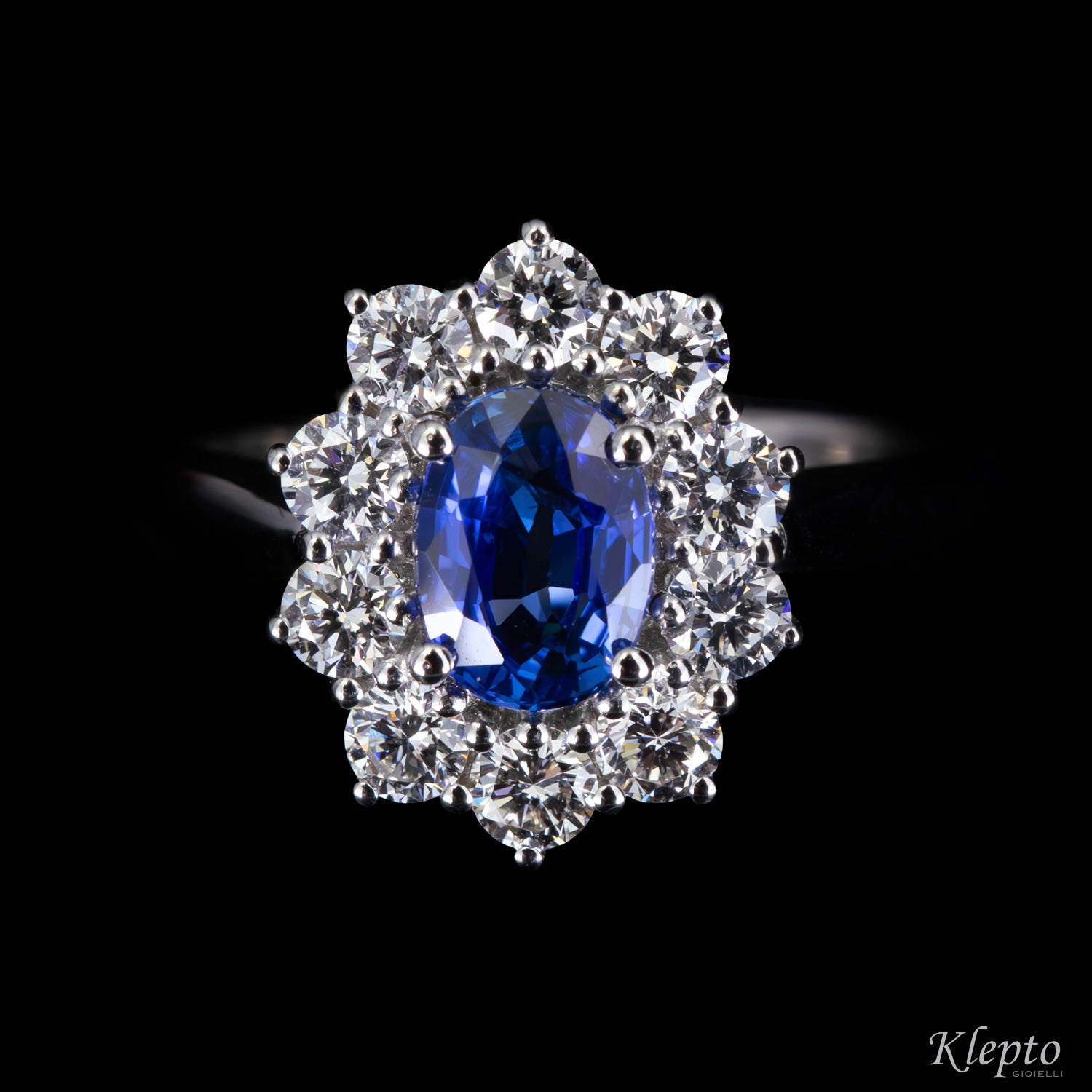 Classic white gold ring with blue sapphire and diamond surround